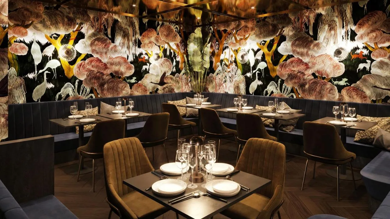 Restaurant dining area with flower-decorated wall at the Covent Garden hotel