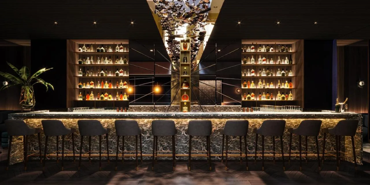 Hotel bar with wine bottles and seating for guests
