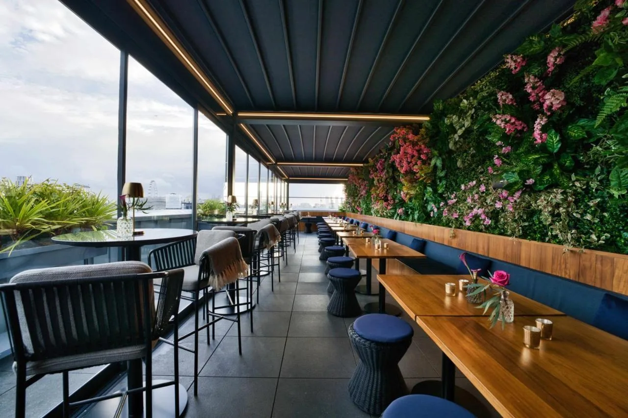 Restaurant with green feature wall, tables and chairs